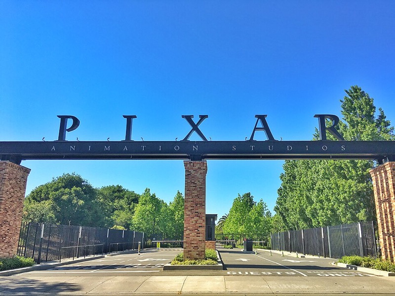 Pixar's brick headquarters building in Emeryville behind a lawn.