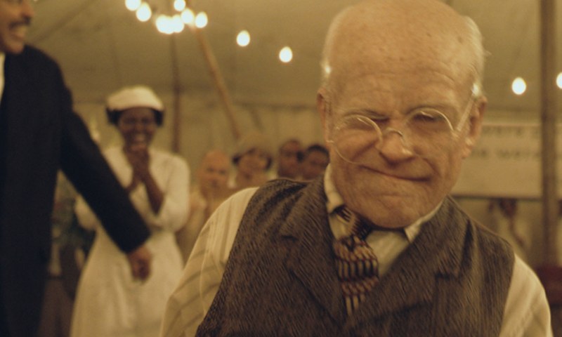 The aged Benjamin Button, an old man's face.