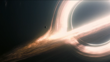 A black hole with a bright accretion disk bent above and below it by gravitational lensing.