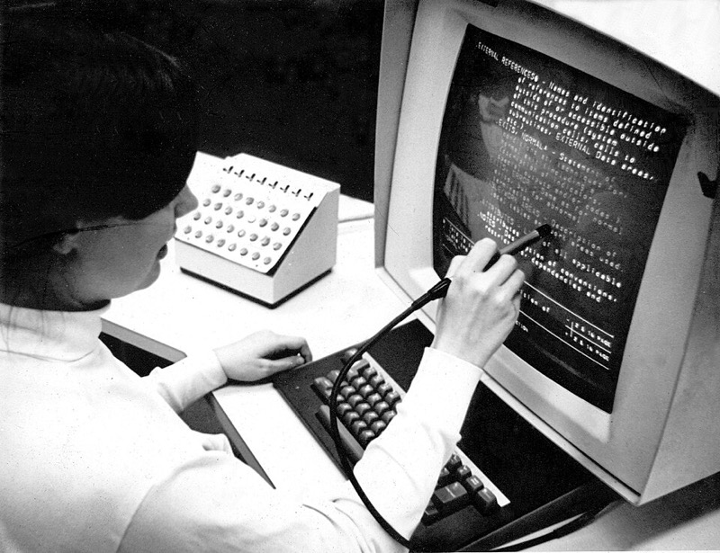 A person using an IBM 2250 display console with a light pen at Brown University, 1969.