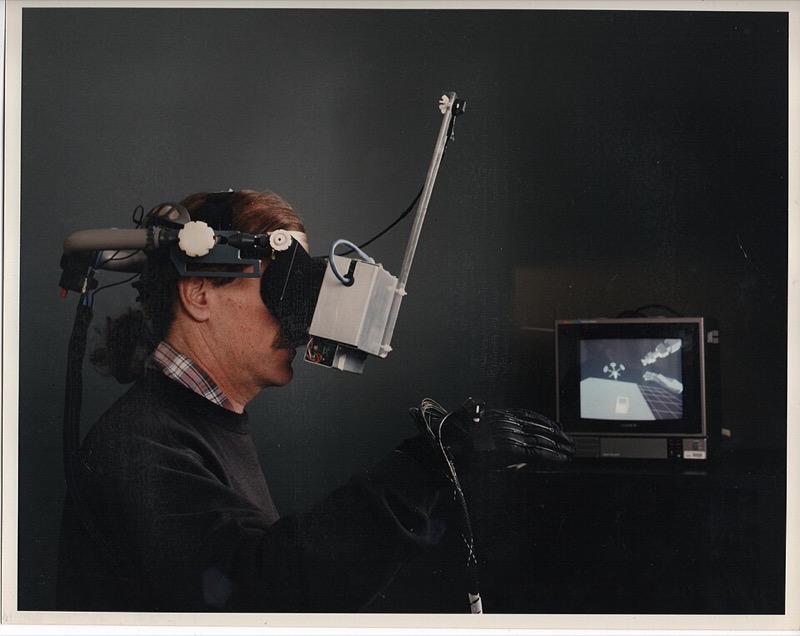 A person wearing the NASA Ames VIEW head-mounted display and a data glove.