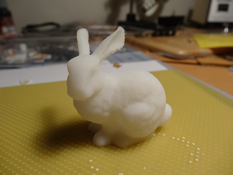 A photograph of a 3D-printed Stanford bunny figurine.