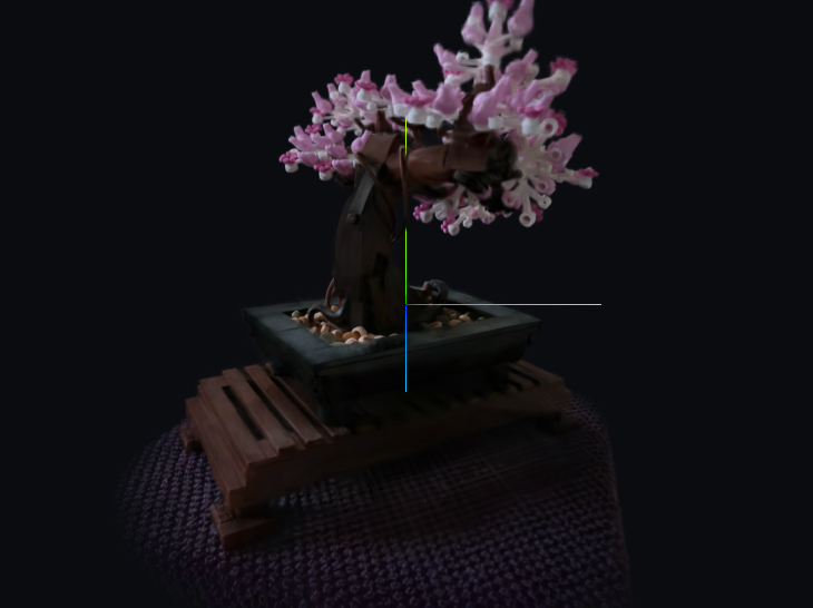 A rendered view of the bonsai scene from the Mip-NeRF 360 dataset: a small tree in a pot on a table, reconstructed from photographs as a cloud of Gaussian splats and drawn in the browser.